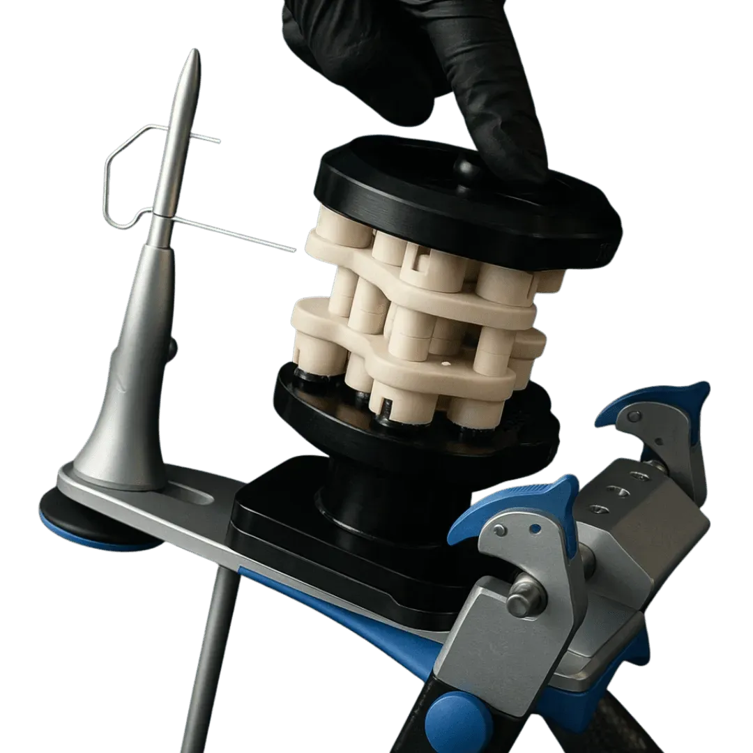 A gloved hand seating a printed calibrator block between the upper and lower DACOS Omni plates on an articulator